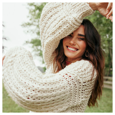 Woman in knitted white sweater