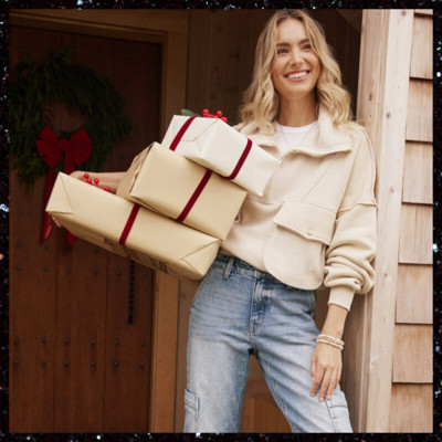 Woman holding wrapped gifts.