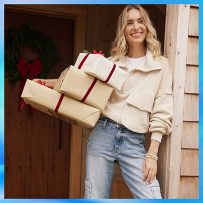Woman holding wrapped gifts.