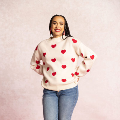 Woman in white sweatshirt with red hearts