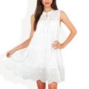  Sleeveless Eyelet Embroidered Tiered A-Line Dress with Tassel Tie Neckline and Scalloped Hem