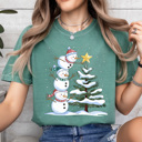 Large Light Green Festive Snowmen Comfort Colors Tee, Winter Snow Graphic Tee, Snowman Shirt