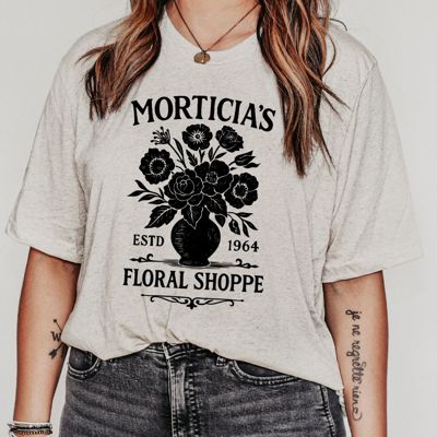 Morticias Floral Shoppe Funny Halloween Adams Puns - T-Shirt (Crewneck)  100 Cotton Solid Colors Jersey Tee (Unisex)  Bella Canvas, T-Shirt (Crewneck)  Poly