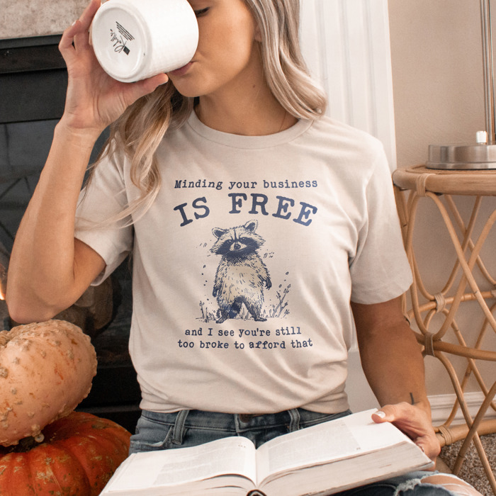 Minding your business is free and i see you're still too broke to afford that. funny Raccoon Wisdom: Mind Your Business Soft Cozy Longer Length Unisex Graphic Tee T-shirt