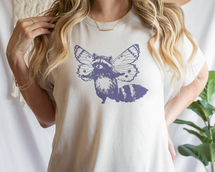 Whimsical Harmony: Raccoon Butterfly Fusion Soft Cozy Longer Length Unisex Graphic Tee T-shirt