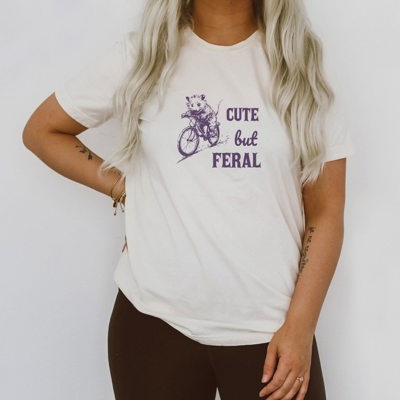 Cute But Feral Little Possum on A Bike Funny Cute Sarcastic Shirts Vintage Animal Sayings Soft Cozy Longer Length Unisex Graphic Tee T-shirt