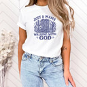  JUST A MAMA WALKING WITH GOD | Boots, Faith, and the Journey of Motherhood Soft Cozy Longer Length Unisex Graphic Tee T-shirt