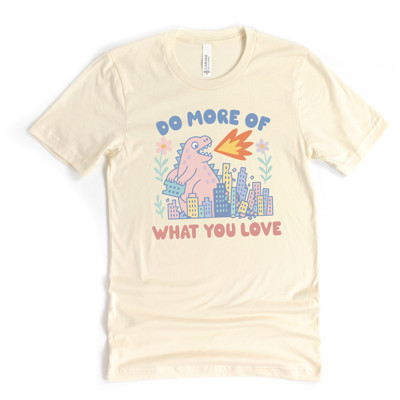 DO MORE OF WHAT YOU LOVE | Unleash the Joy: A Dinosaur's Delight Soft Cozy Longer Length Unisex Graphic Tee T-shirt
