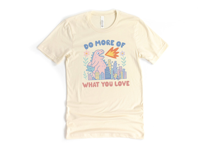 DO MORE OF WHAT YOU LOVE | Unleash the Joy: A Dinosaur's Delight Soft Cozy Longer Length Unisex Graphic Tee T-shirt