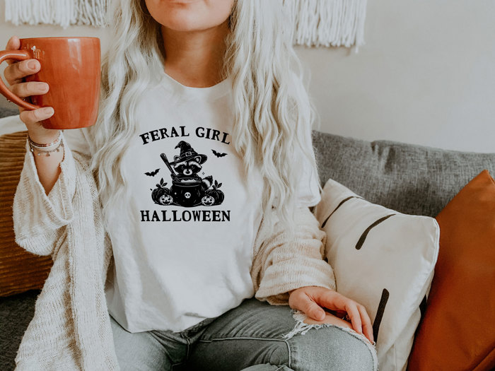 FERAL GIRL HALLOWEEN | Enchanted Mischief: A Spooky Tale of a Trickster's Brew Soft Cozy Longer Length Unisex Graphic Tee T-shirt