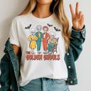  The Golden Ghouls Graphic Tee – Funny Halloween Skeleton Squad Shirt, Retro Spooky Season Top for Women