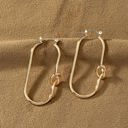  Very Carrot Brass oval hoop with love knots earrings