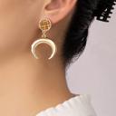  Very Carrot Metal horn drop earrings topped by a woven rattan disk