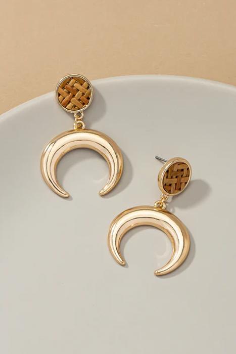 Very Carrot Metal horn drop earrings topped by a woven rattan disk