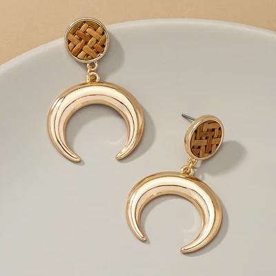 Very Carrot Metal horn drop earrings topped by a woven rattan disk