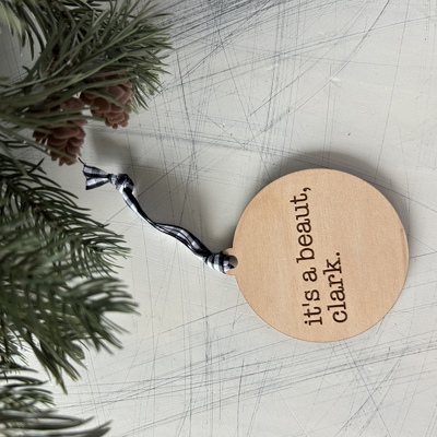 It's a beaut, clark. - Engraved Maple Ornament with Buffalo Plaid Ribbon