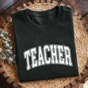  TEACHER Graphic T-Shirt – Unisex Fit, Back to School Teacher Shirt, College Style Block Letters, Gift for Educators, Comfy Everyday Tee