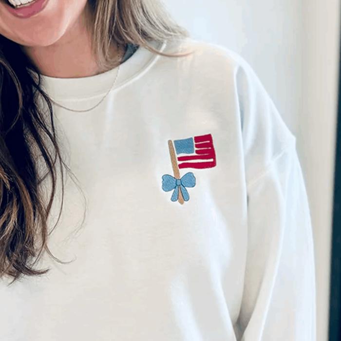 Embroidered Mini Flag & Bow 4th of July Sweatshirt – Cute Patriotic Crewneck for Women, USA Flag Embroidery, Independence Day Outfit